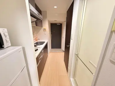 a small kitchen with a hallway leading to a room at S5 Shibuya center-350m from Shibuya St ation in Tokyo