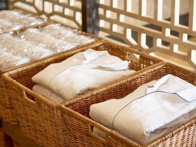 two baskets filled with white towels on a table at The OneFive Tokyo Kameido in Tokyo