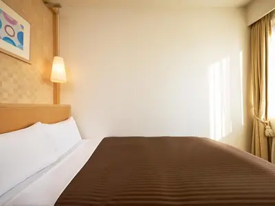 a bedroom with a bed and a window at The OneFive Tokyo Kameido in Tokyo
