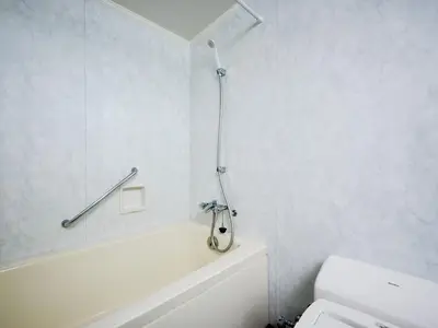 a bathroom with a white tub and a toilet at The OneFive Tokyo Kameido in Tokyo