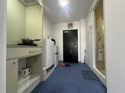 a kitchen with a black door and a refrigerator at Aakabane Apart ment 3 Wei hefuyan7190 in Tokyo