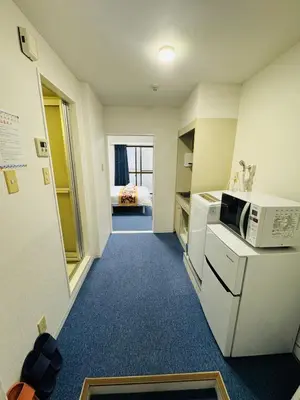 a small room with a kitchen with a microwave at Aakabane Apart ment 3 Wei hefuyan7190 in Tokyo