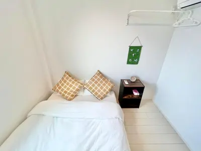 a small room with a bed and a side table at 君の家AOTO#Haneda&Narita Access#Free reserved parking in Tokyo