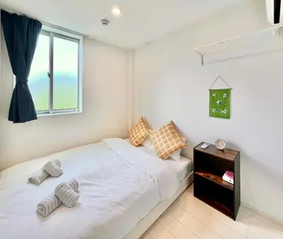 a bedroom with a white bed and a window at 君の家AOTO#Haneda&Narita Access#Free reserved parking in Tokyo