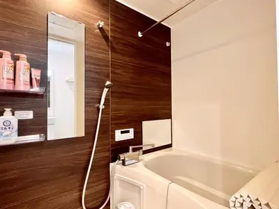 a bathroom with a bath tub and a mirror at 君の家AOTO#Haneda&Narita Access#Free reserved parking in Tokyo