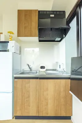 a kitchen with a sink and a refrigerator at Shinjuku Waseda Haruno B&B in Tokyo
