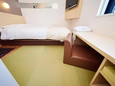 a small room with a bed and a desk at Super Hotel Akihabara Suehirocho in Tokyo