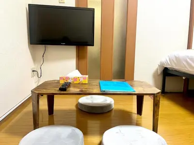 a wooden table with a tv and two stools at S,F, Heights - Vacation STAY 18008 in Tokyo