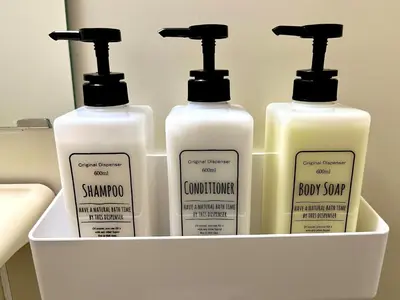 four bottles of shampoo and conditioner in a container at S,F, Heights - Vacation STAY 18008 in Tokyo
