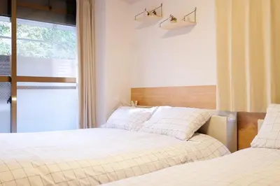 two beds sitting next to each other in a bedroom at Heisei Mansion - Vacation STAY 18017 in Tokyo