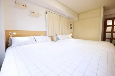 a large white bed in a room with a window at Heisei Mansion - Vacation STAY 18017 in Tokyo