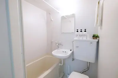 a bathroom with a sink and a toilet and a bath tub at Heisei Mansion - Vacation STAY 18017 in Tokyo