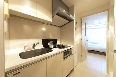 a small kitchen with a sink and a stove at SQUARE Shibuya Room 901 - Vacation STAY 57159v in Tokyo