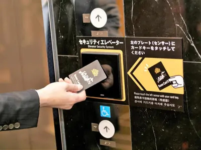 a person holding a credit card in front of a machine at APA Hotel Akabane Iwabuchi Ekimae in Tokyo