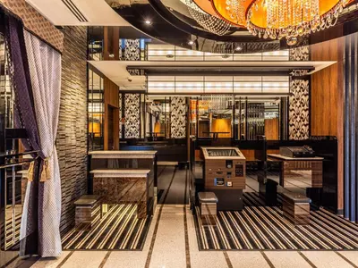 a restaurant with a bar with a dj in it at APA Hotel Akabane Iwabuchi Ekimae in Tokyo