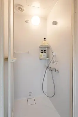 a bathroom with a shower with a shower head at \u6771\u65b0\u5bbf 1112 in Tokyo