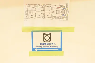 a floor plan of a restroom with a sign that reads washing machine is that way at Higashi-Shinjuku 902 in Tokyo