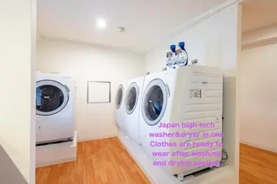 a laundry room with two washers and a dryer at Higashi-Shinjuku 906 in Tokyo