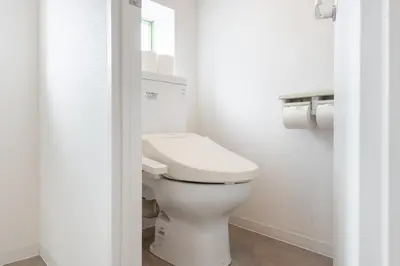 a white bathroom with a toilet and a window at Higashi-Shinjuku 905 in Tokyo