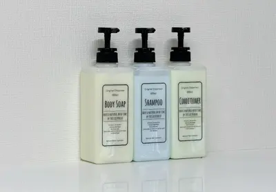 three bottles of soap and moisturizers sitting on a shelf at Higashi-Shinjuku 905 in Tokyo