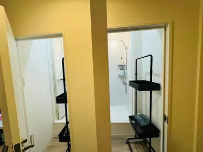 a bathroom with a mirror and a shower in a room at Higashi-Shinjuku 14F in Tokyo