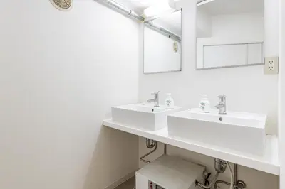 a white bathroom with two sinks and a mirror at \u6771\u65b0\u5bbf 1104 in Tokyo