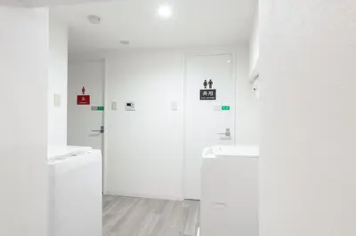 a white bathroom with two sinks and a washing machine at \u6771\u65b0\u5bbf 1104 in Tokyo