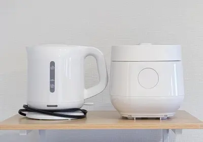 two white appliances sitting on a wooden shelf at \u6771\u65b0\u5bbf 1104 in Tokyo