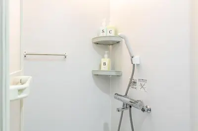 a bathroom with a shower and a sink in a room at \u6771\u65b0\u5bbf 1105 in Tokyo