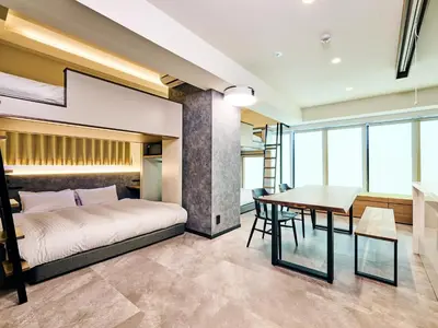 a bedroom with a bed and a table and a dining room at HOTEL ALL IN TOKYO Asakusabashi in Tokyo