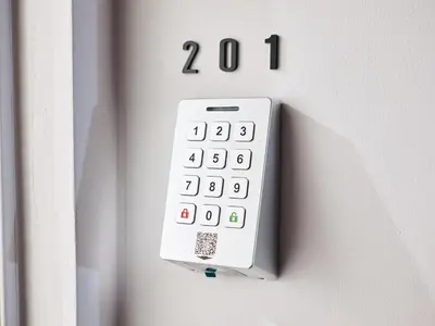 a white calculator is attached to a wall at HOTEL ALL IN TOKYO Asakusabashi in Tokyo