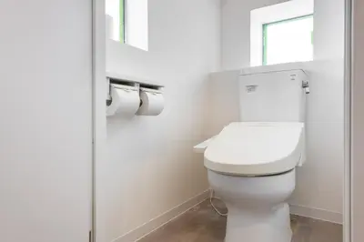 a white toilet in a bathroom with a window at \u6771\u65b0\u5bbf 1106 in Tokyo