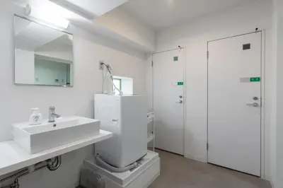 a white bathroom with a sink and a mirror at \u6771\u65b0\u5bbf 1109 in Tokyo