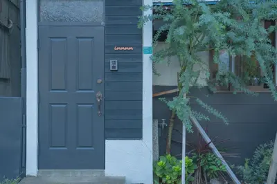 a blue door on the side of a house at innnn higashinagasaki in Tokyo