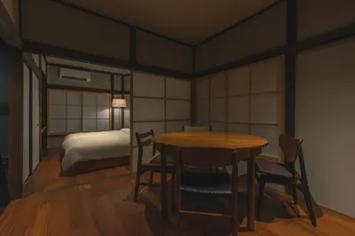 a room with a table and chairs and a bed at innnn higashinagasaki in Tokyo