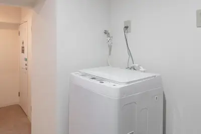 a white refrigerator with a cord on top of it at \u6771\u65b0\u5bbf 1107 in Tokyo