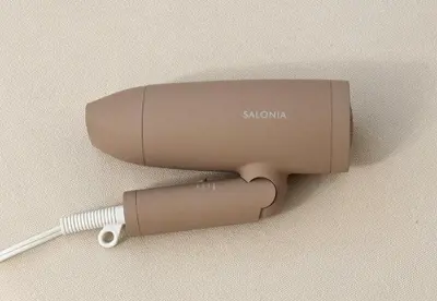 a hair dryer sitting on a wall at \u6771\u65b0\u5bbf 1107 in Tokyo