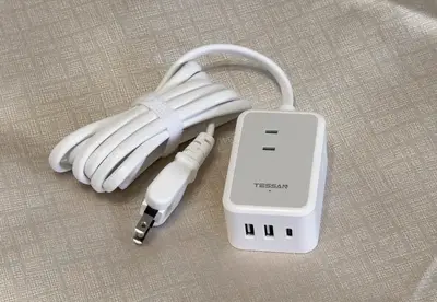 a white ipod plugged into a white charger at \u6771\u65b0\u5bbf 1107 in Tokyo