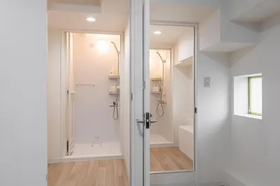 a bathroom with a shower and a glass door at \u6771\u65b0\u5bbf 1107 in Tokyo