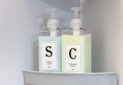 two bottles of soap sitting on a shelf at \u6771\u65b0\u5bbf 1108 in Tokyo