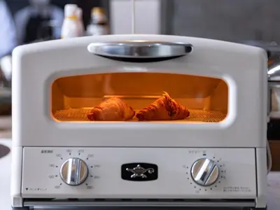 a toaster oven with some food inside of it at SUPER HOTEL Ikebukuro West Natural Hot Spring in Tokyo