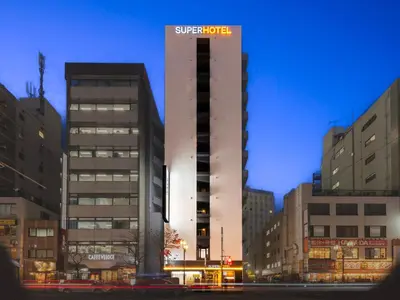 a building with a sign on the side of it at SUPER HOTEL Ikebukuro West Natural Hot Spring in Tokyo