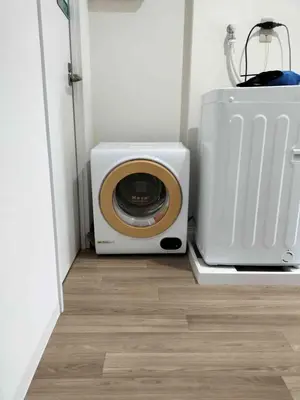 a small white microwave next to a toaster oven at Higashi-Shinjuku 1002 in Tokyo