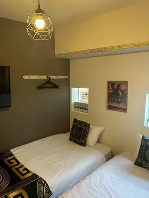 a bedroom with two beds and a light fixture at Higashi-Shinjuku 1002 in Tokyo