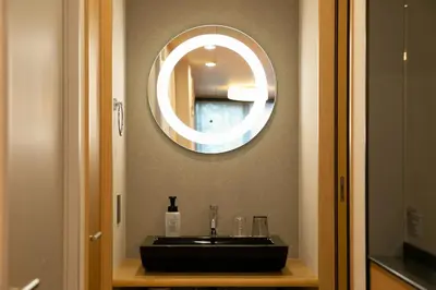 a bathroom with a black sink and a mirror at \u85cd-Ai-ASAKUSA in Tokyo