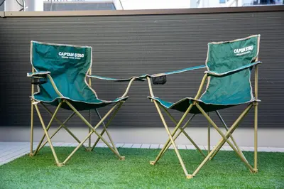 two green chairs sitting next to each other at \u85cd-Ai-ASAKUSA in Tokyo
