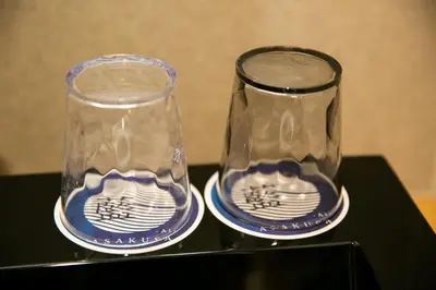 two empty glasses sitting on a black table at \u85cd-Ai-ASAKUSA in Tokyo
