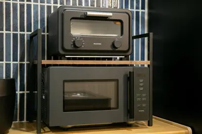 a microwave and a toaster oven sitting on top of a toaster oven at \u85cd-Ai-ASAKUSA in Tokyo