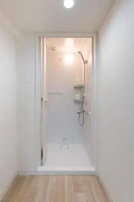 a white bathroom with a shower in a room at Higashi-Shinujuku 1008 in Tokyo