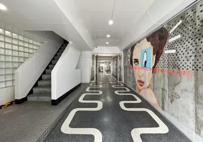 a hallway with a painting of a cow on the wall at -Higashi Shinjuku 1009- in Tokyo